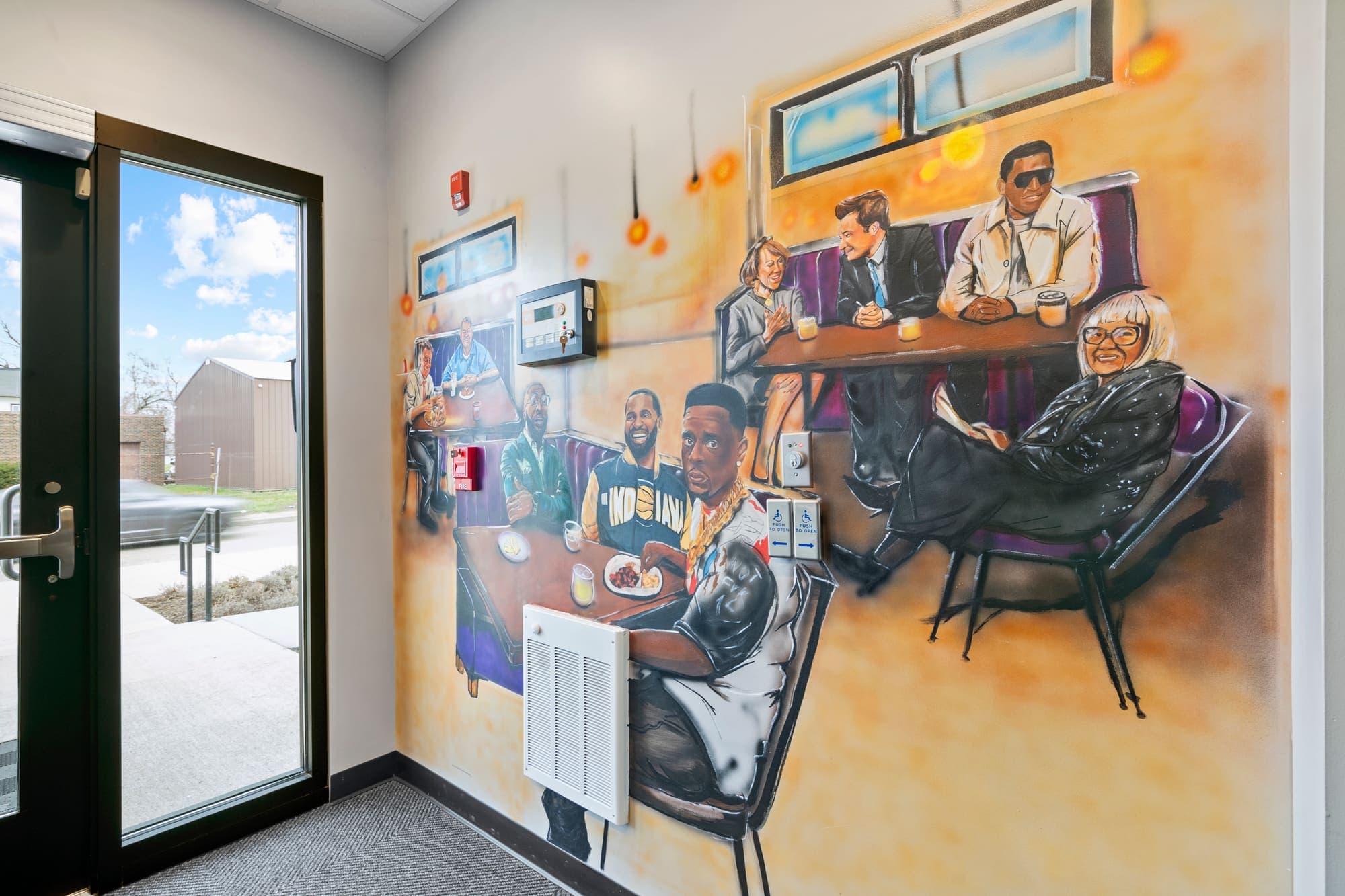 Dining room with painted mural wall and banquette seating